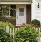 Installed white steel exterior door with 1 lite glass and two lower raised panels