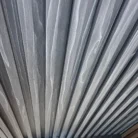 Dark Grey 4-Track Louver WPC panels stacked for product display