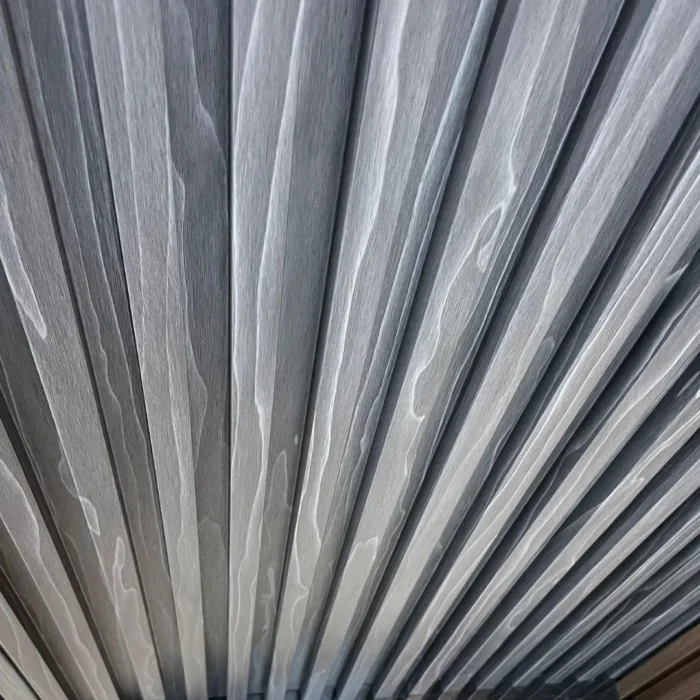 Dark Grey 4-Track Louver WPC panels stacked for product display