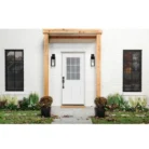 Installed white 9 Lite over 2 panel steel entry door with internal grid clear glass in a modern home exterior.