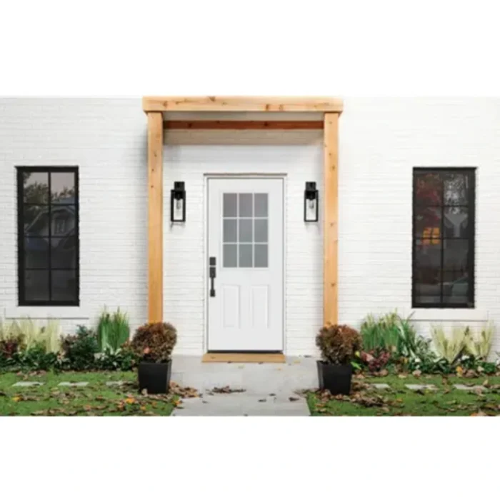 Installed white 9 Lite over 2 panel steel entry door with internal grid clear glass in a modern home exterior.