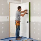 Completed professional door installation with Reno Materials logo